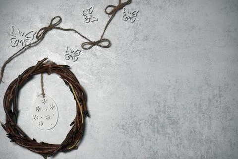 The easter wreath from branches vines with thread on grey background with c.. Stock Photos