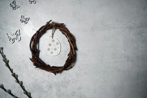 The easter wreath from branches vines with thread on grey background with c.. Stock Photos