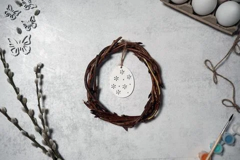 Easter wreath from branches vines with thread on grey background with copyspa Stock Photos