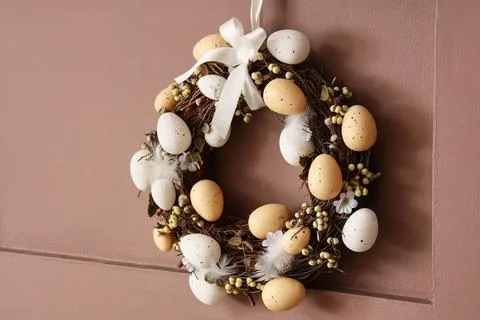 Easter wreath hanging on brown wall Stock Photos