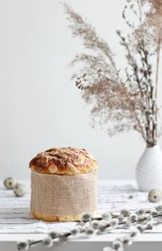 Easter yeast bread or cake with willow sprigs on the table. Easter concept Stock Photos