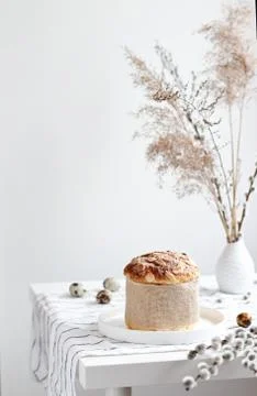 Easter yeast bread or cake with willow sprigs on the table. Easter concept Stock Photos