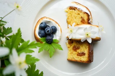 Easter yeast cake covered with icing and decorated with edible flowers Stock Photos