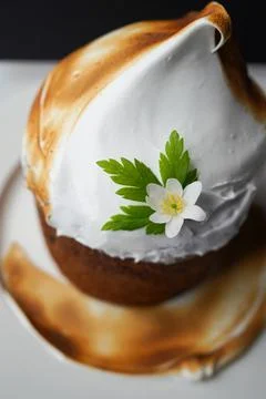 Easter yeast cake covered with icing and decorated with edible flowers Stock Photos