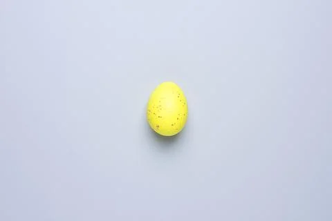 Easter yellow egg on grey background. Flat lay, copy space beautiful Stock Photos