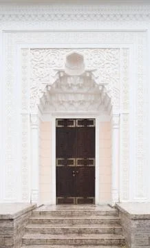 Eastern architecture element. White wall and wooden door Stock Photos