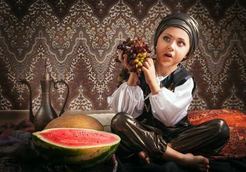 Eastern boy with grape portrait Stock Photos