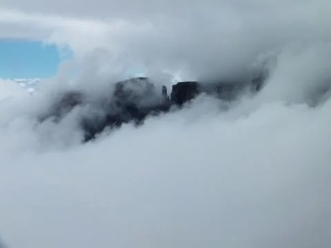 Eastern Buttress appearing through the clouds Stock Photos