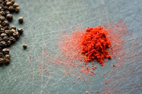Eastern condiments scattered on a table at home. Turmeric and pe Stock Photos