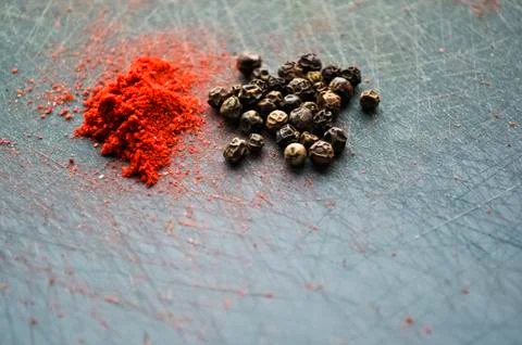 Eastern condiments scattered on a table at home. Turmeric and pe Stock Photos
