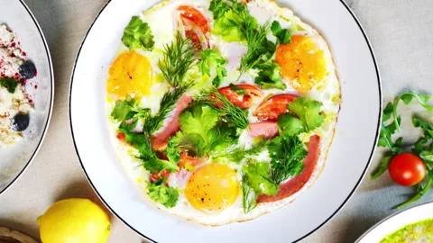 Eastern European breakfast spread featuring porridge, eggs, pancakes, and crepes Stock Footage 312359339