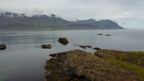 Eastern Icelandic drone shot of small lighthouse near coast Stock Footage 84442575