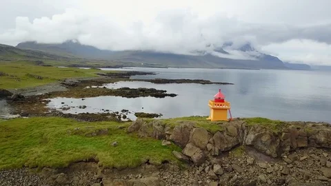 Eastern Icelandic drone shot of small lighthouse near coast Stock Footage 84443044