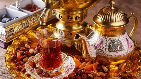 Eastern tea with nuts sweets Stock Photos