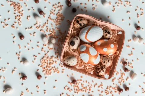 Easter.Top view of golden pattern eggs in wicker basket on a white background 스톡 사진