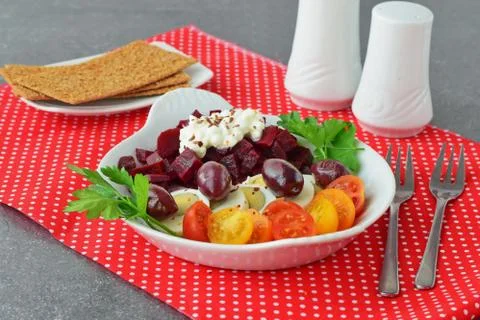 Easy breakfast : beetroots, cherry tomato, egg, cottage cheese and crisps. Stock Photos