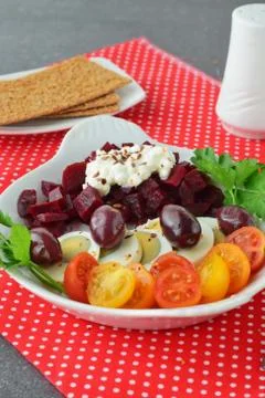Easy breakfast : beetroots, cherry tomato, egg, cottage cheese and crisps. Stock Photos
