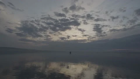 Easy clouds float over still water. Stock Footage 143041733