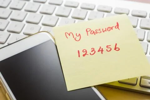 Easy number password note stick on smartphone, keyboard. Stock Photos