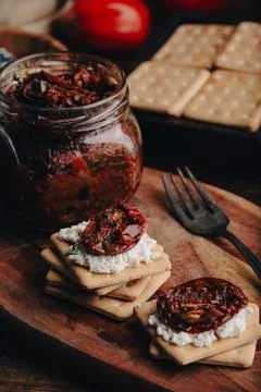 Easy snack with crackers, sun-dried tomatoes and cream cheese Stock Photos