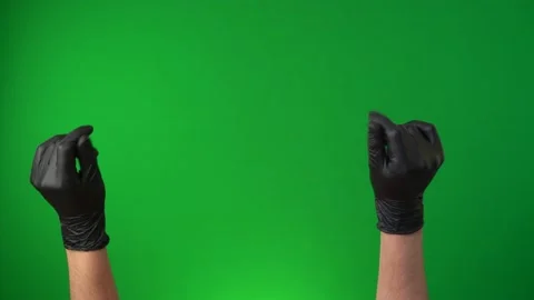 Easy, snap gesture. Hands in a black medical gloves isolated on a green screen Stock Footage 131611075