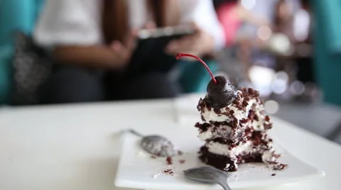 Eat cake and using tablet in cafe, video HD Stock Footage 57534471