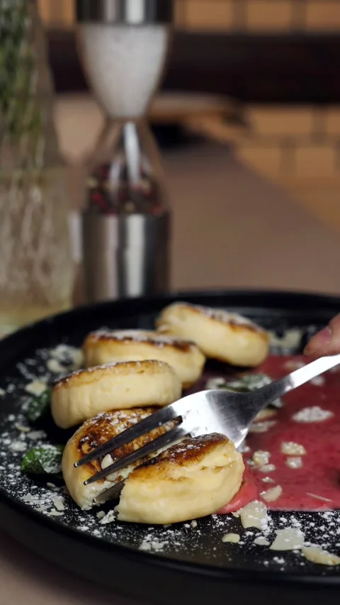 Eat cheese pancakes. Bite a cheesecake with a fork. Sweet breakfast. sweet food Stock Footage 309307489