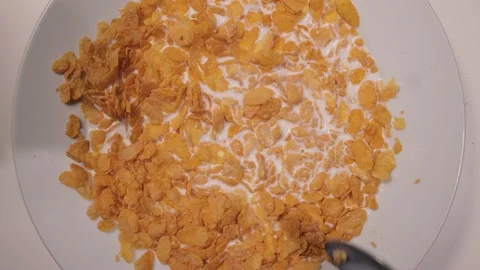Eat cornflakes with milk for breakfast Stock Footage 151058627