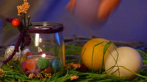 Eater Hen Eggs Are Put on a Traditional Easter Table With a Bottle and a Lit Stock Footage 72890839