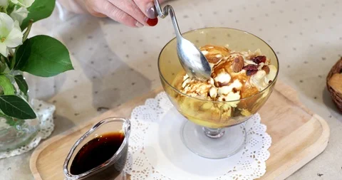 Eating affogato with nuts with spoon Stock Footage 103564554