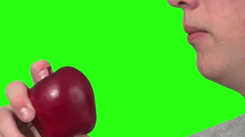 Eating an apple, green background Stock Footage 49862421