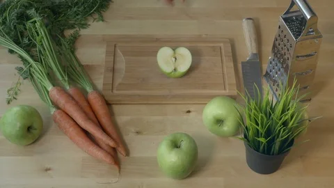Eating apple from the kitchen table in spring time view from above. Stock Footage 75623947