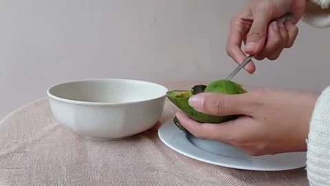 Eating the avocado with a silver spoon Stock Footage 149957156