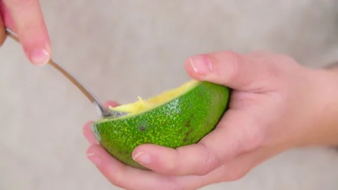 Eating avocado with a small spoon Stock Footage 83725260