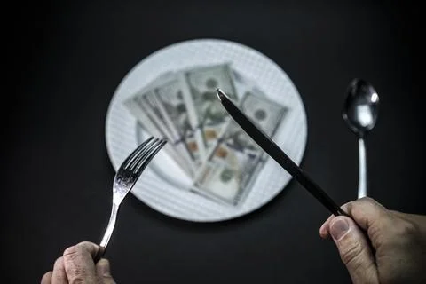  Eating Banknotes on a Portion Plate, A Creative Representation of Consuming Mon Stock Photos