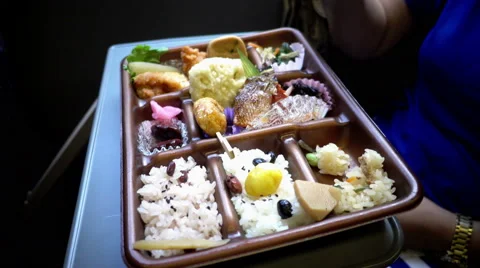 Eating Bento Japanese set on the train moving, 4K Stock Footage 68897930