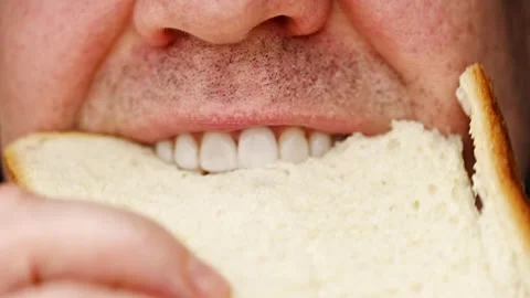 Eating bread in close-up from different angles during lunch hour 動画素材 331144057