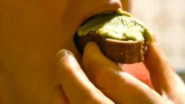 Eating bread with fresh avocado, close up Stock Footage 86021302