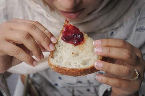 Eating bread with jam during a meal at home Stock Photos