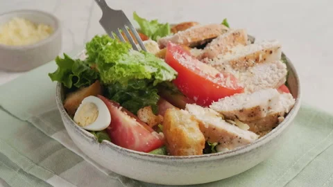 Eating Caesar salad with fork. Healthy food Stock Footage 220481329
