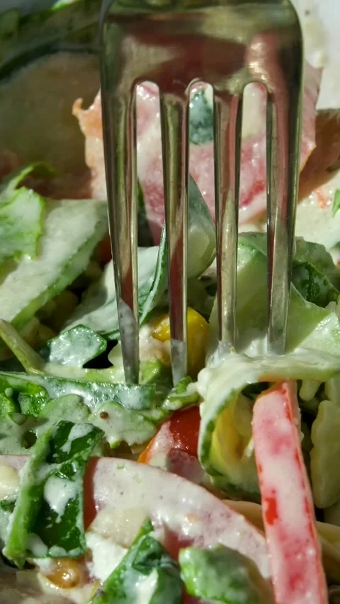 Eating Caesar salad with fork. Healthy salad made of chicken fillet, lettuce Stock Footage 323920720
