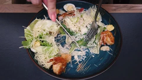 Eating caesar salad with parmesan cheese and chicken. Stock Footage 154754605