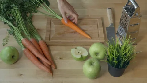 Eating carrot from the kitchen table in spring time view from above. Stock Footage 75623958