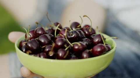 Eating a cherries from plate Stock Footage 68301002