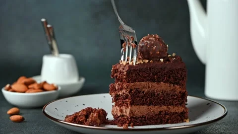 Eating chocolate cake. Taking a bite of chocolate cake with a fork. Hazelnut Stock Footage 171545490