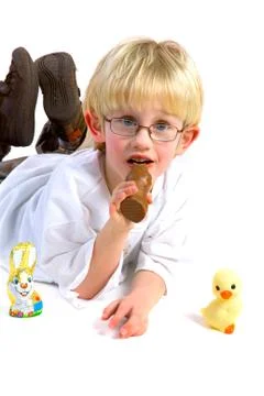 Eating a chocolate easter hare Stock Photos