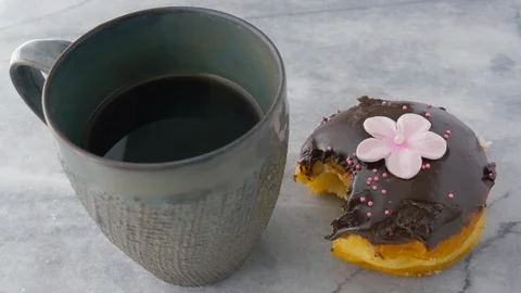 Eating a Chocolate Glazed Donut Stock Footage 106157615