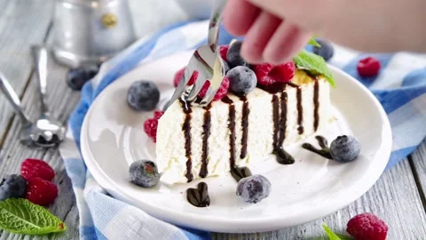 Eating classic cheesecake with berries Stock Footage 169587335