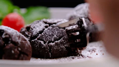 Eating cocoa balls stuffed with dark chocolate with fork. Sweet Food Stock Footage 177435257