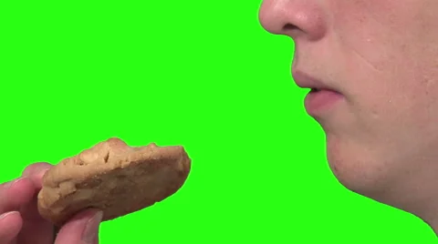Eating a cookie, green background Stock Footage 49862486